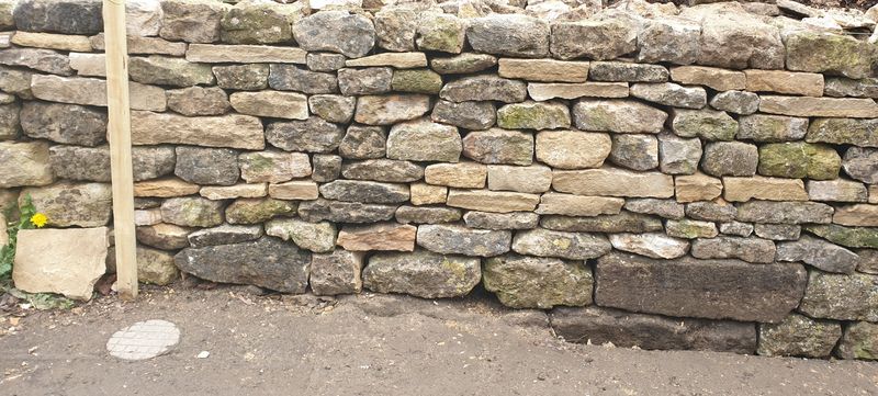 Rebuilt Cotswold stone wall face