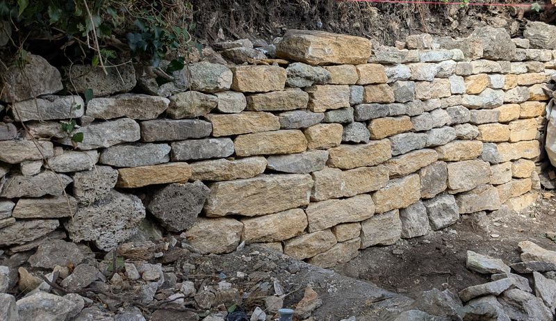 Collapsed retaining wall being rebuilt